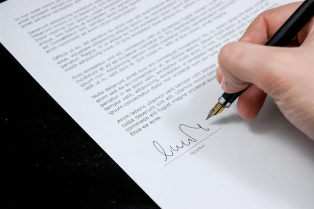 a person signing a form