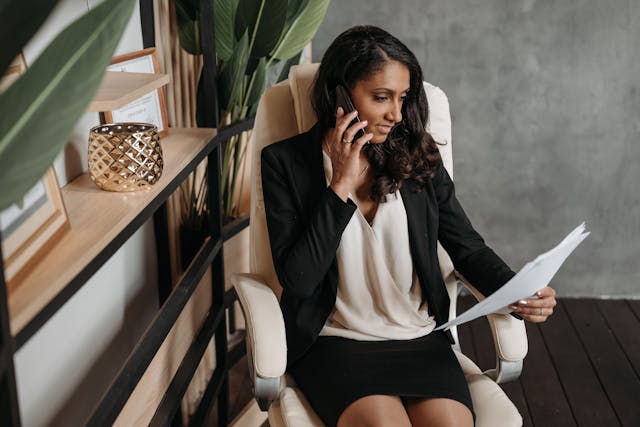 a person sitting at their desk talking on the phone