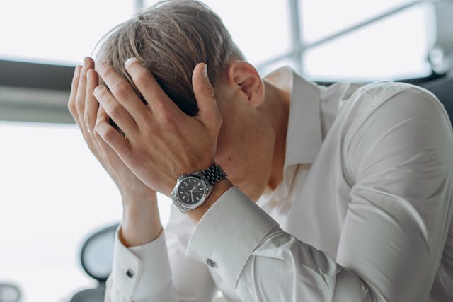 a person with their head in their hands