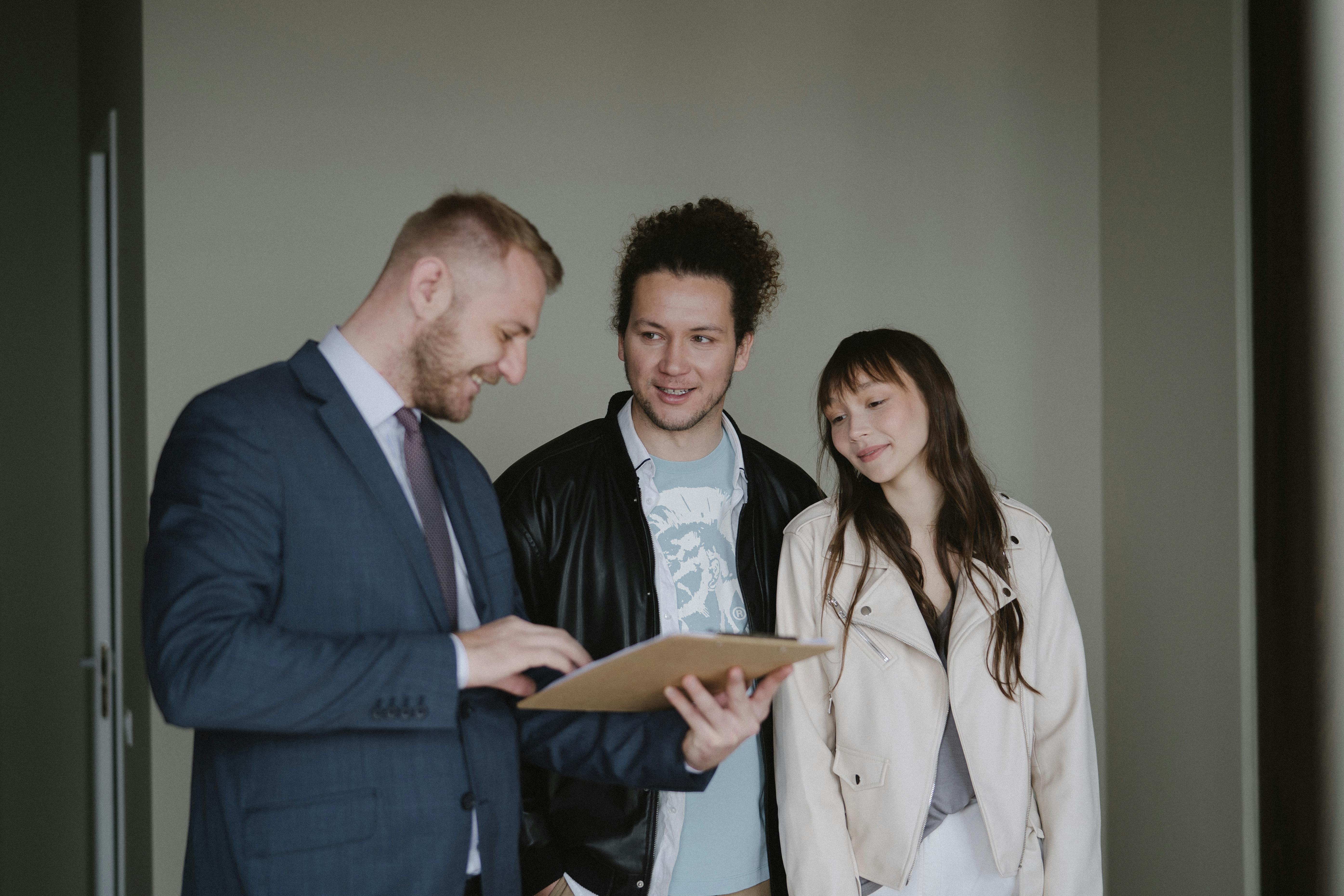 three people, one in suit with clipboard