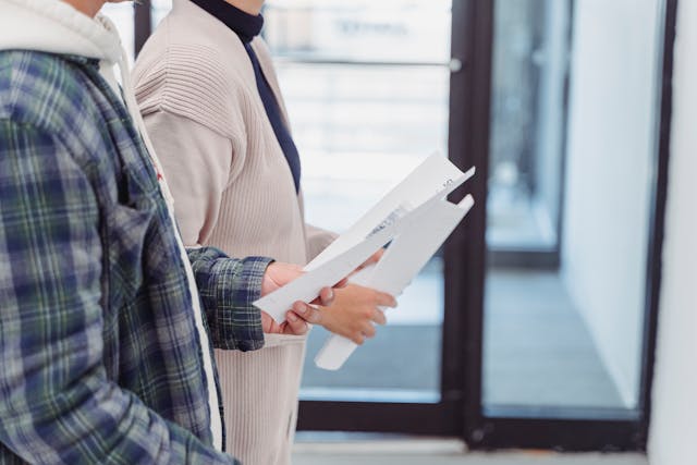 two people holding papers
